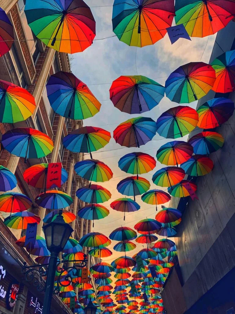 multi colored umbrella hanging on the wall