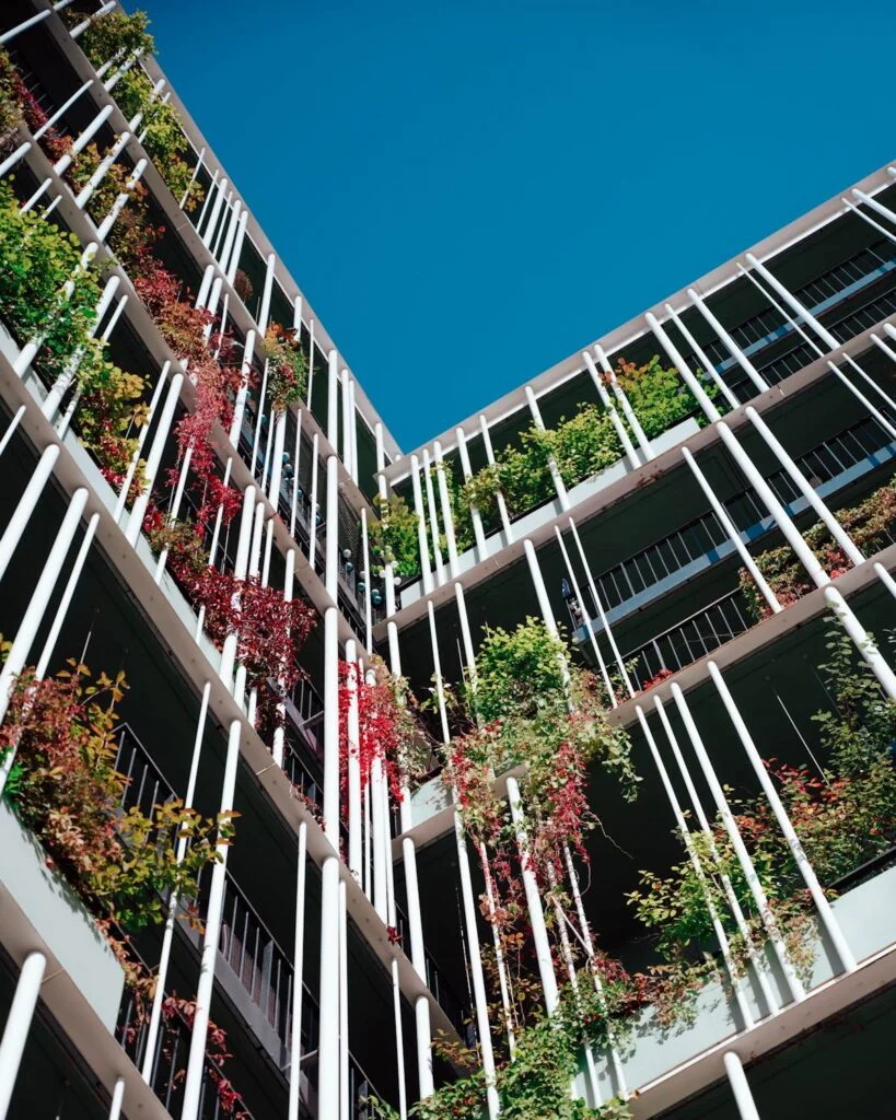a very tall building with lots of plants growing on it